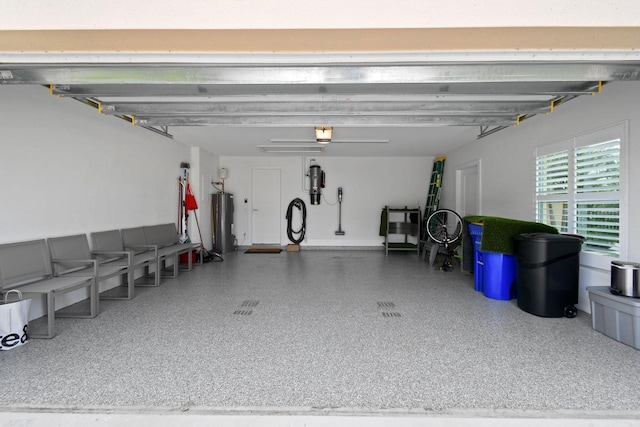 garage featuring water heater and a garage door opener