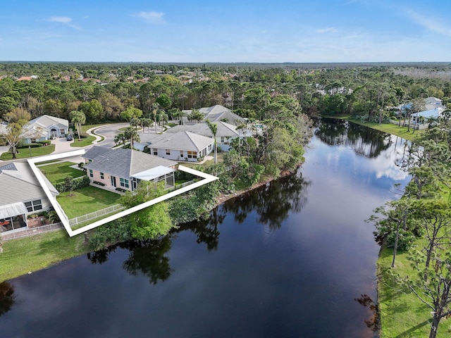 birds eye view of property featuring a water view and a forest view