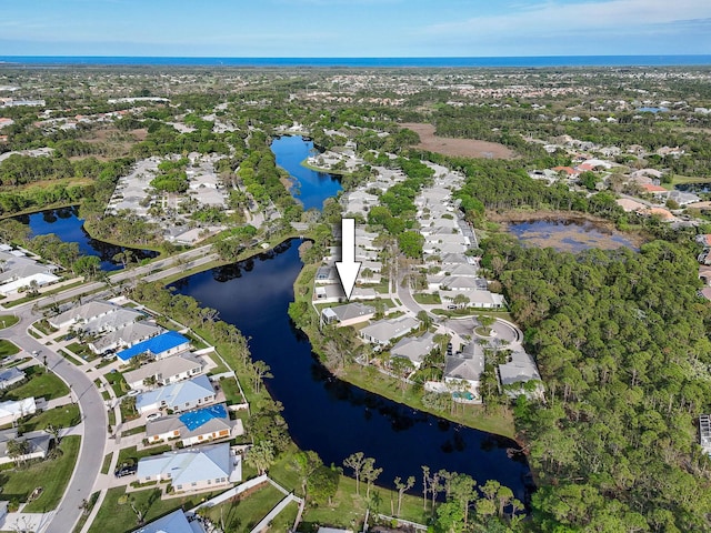 birds eye view of property with a water view and a residential view