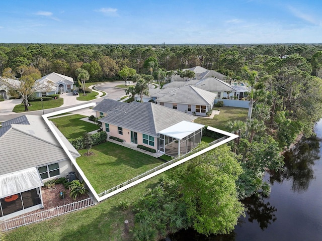 drone / aerial view featuring a water view and a wooded view