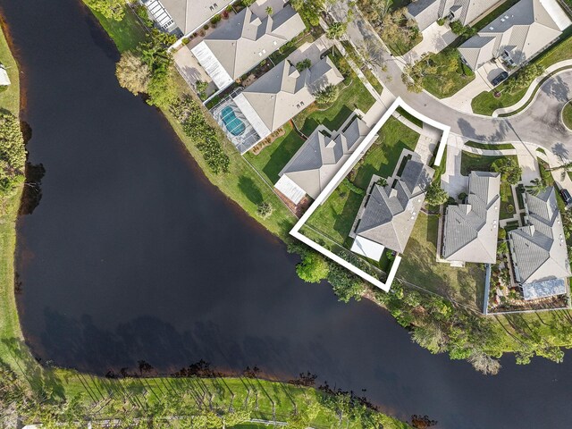 drone / aerial view featuring a residential view and a water view