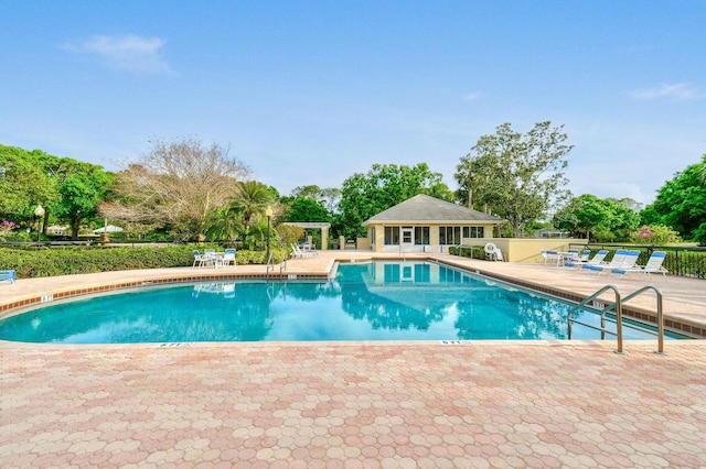 community pool featuring a patio and fence