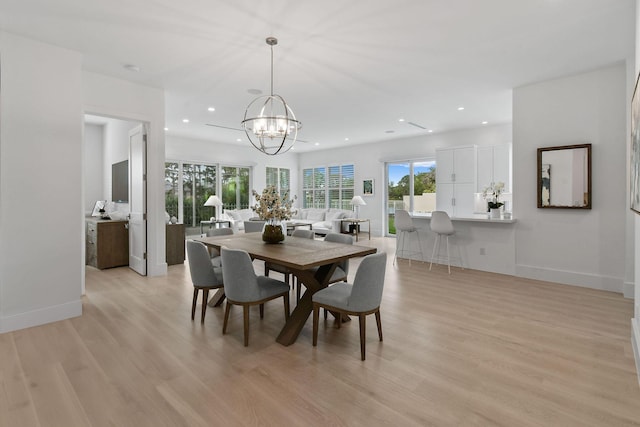 dining space with light wood-style floors, baseboards, a notable chandelier, and recessed lighting