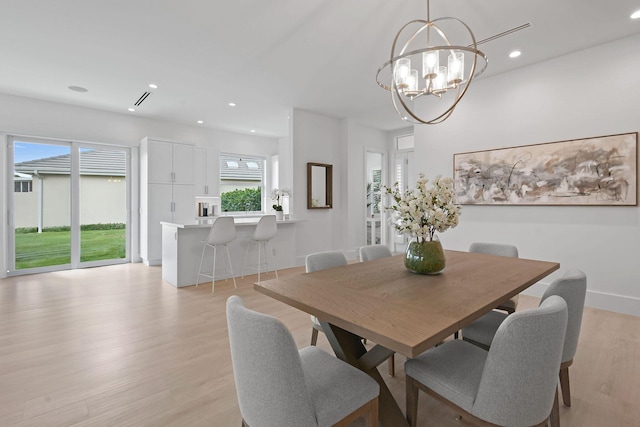 dining room with a chandelier, light wood-type flooring, and recessed lighting