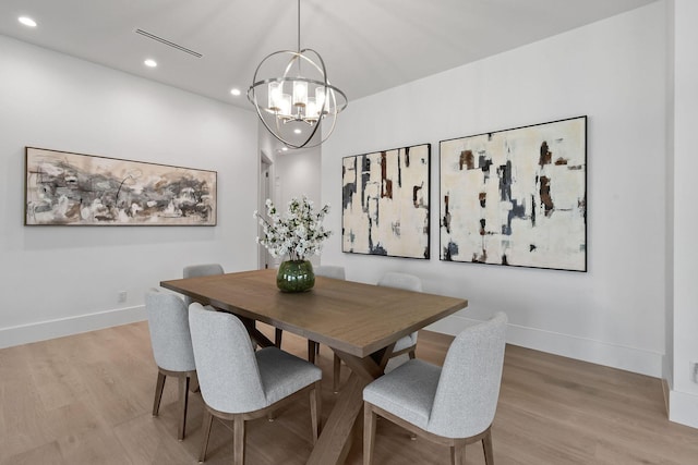 dining area with light wood-style floors, recessed lighting, a chandelier, and baseboards