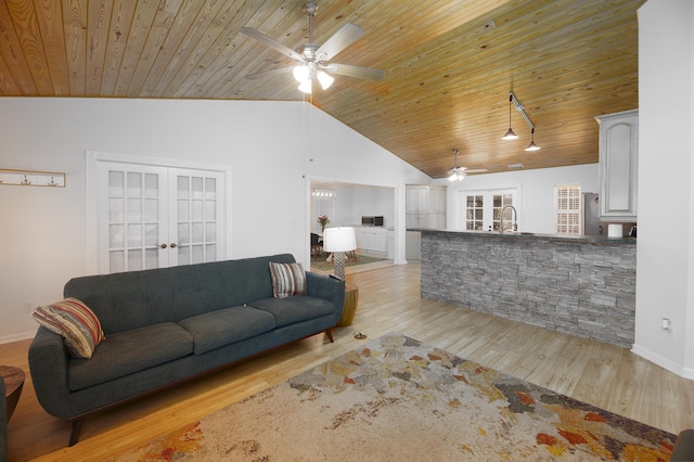 living room with lofted ceiling, french doors, wooden ceiling, and light wood finished floors