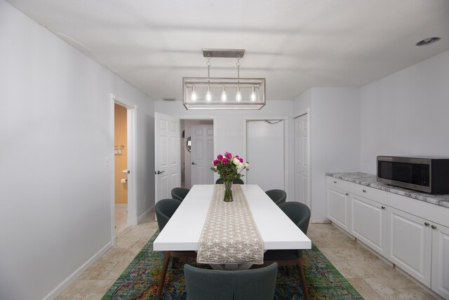 dining space featuring baseboards