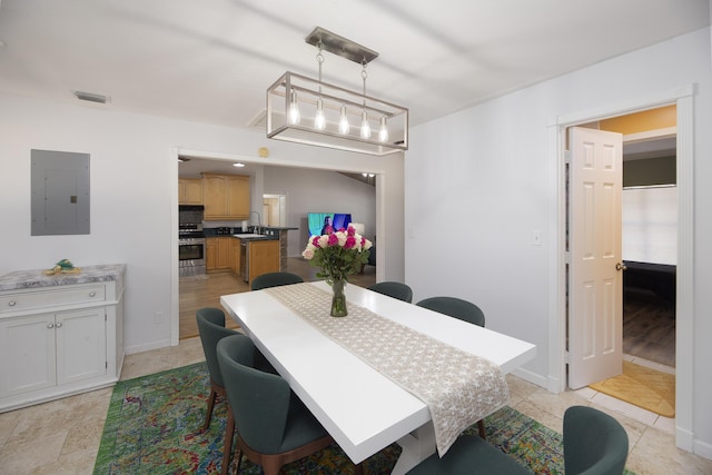 dining room with baseboards, electric panel, and visible vents