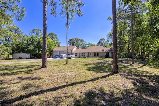 view of front facade featuring an attached garage and a front lawn