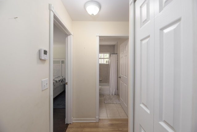 hallway featuring light tile patterned floors