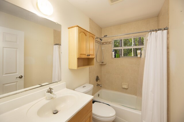 full bathroom featuring toilet, visible vents, shower / bath combination with curtain, and vanity