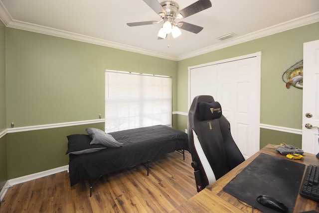 bedroom with ornamental molding and wood finished floors