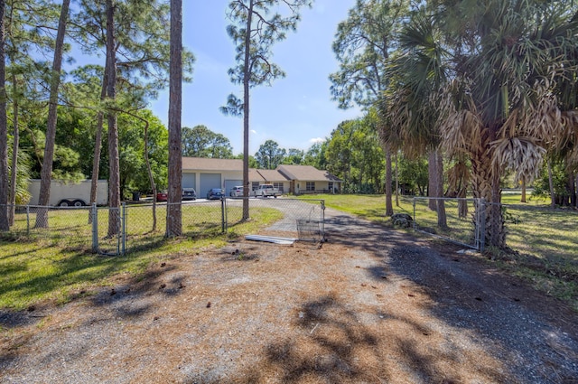 view of yard featuring a garage and fence