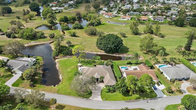 drone / aerial view featuring a residential view and a water view