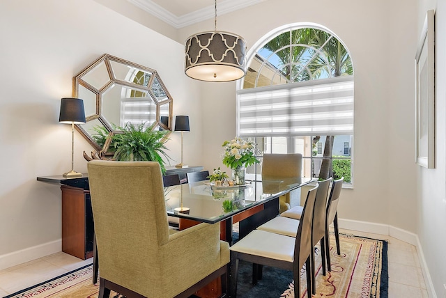 dining area featuring tile patterned flooring, crown molding, and baseboards