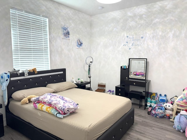 bedroom featuring wood finished floors