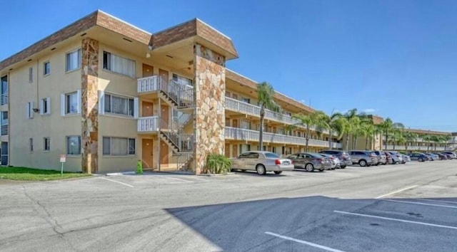 view of building exterior with uncovered parking