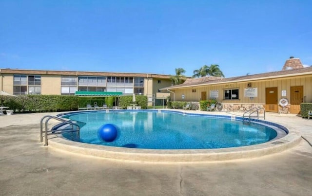 community pool featuring a patio area