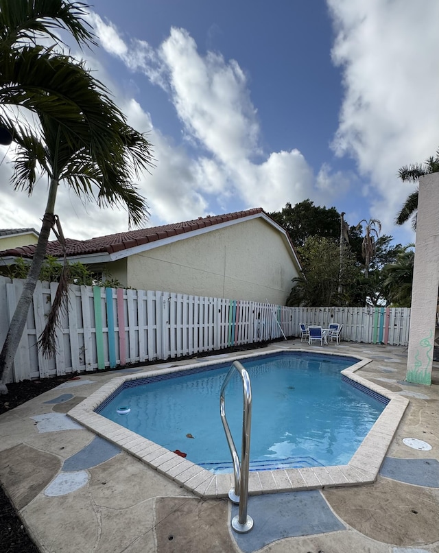 view of pool featuring a fenced in pool, a fenced backyard, and a patio