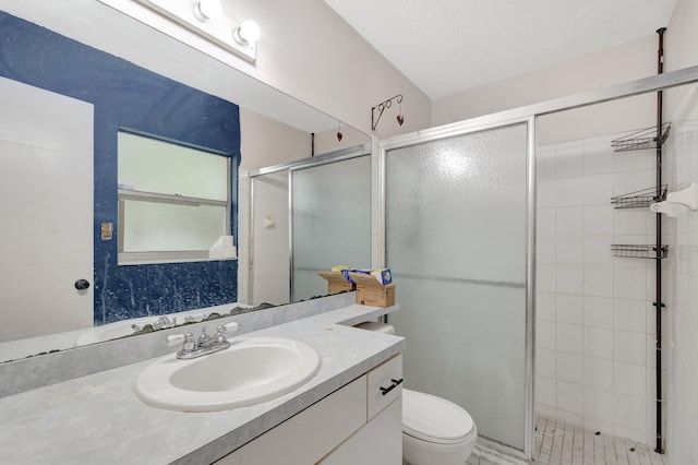 bathroom featuring toilet, a shower stall, and vanity