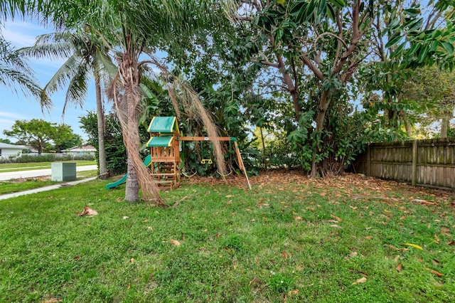 view of playground with a yard and fence