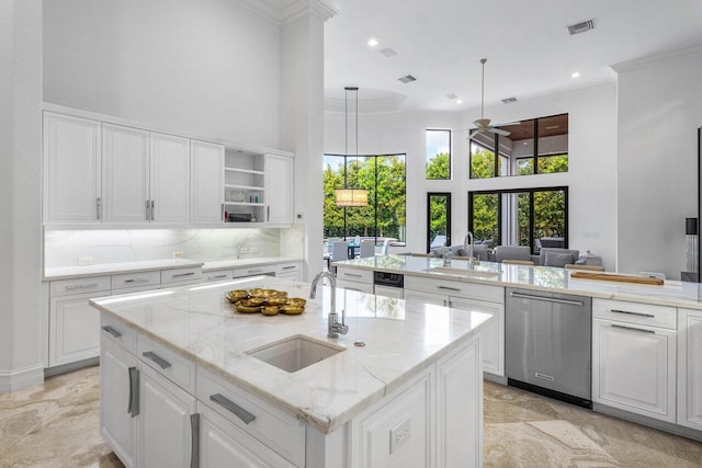 kitchen featuring dishwasher, visible vents, a sink, and ornamental molding