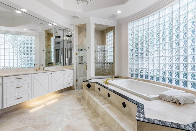 full bathroom featuring crown molding, a shower stall, vanity, and a bath