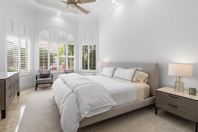 bedroom with a ceiling fan, crown molding, a towering ceiling, and baseboards