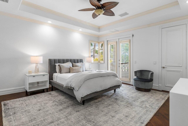 bedroom featuring a tray ceiling, access to outside, crown molding, and baseboards