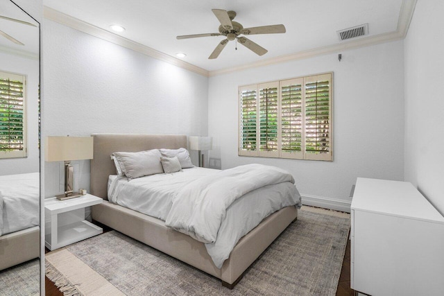 bedroom featuring visible vents, crown molding, and multiple windows