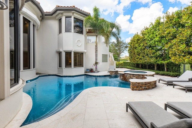 view of pool featuring a pool with connected hot tub and a patio