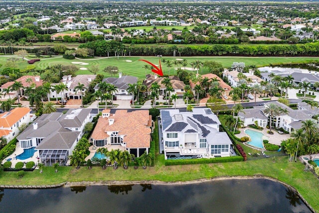 bird's eye view with golf course view, a water view, and a residential view