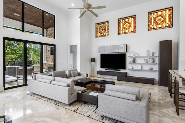 living room with a ceiling fan, a towering ceiling, marble finish floor, crown molding, and recessed lighting