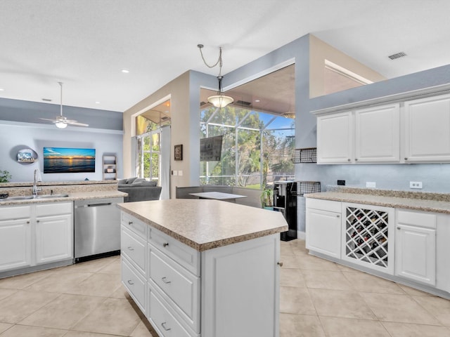 kitchen with light tile patterned floors, a sink, visible vents, light countertops, and dishwasher