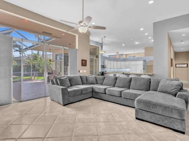 living room with light tile patterned floors, a ceiling fan, and recessed lighting