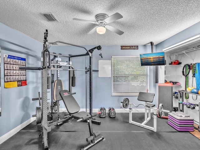 exercise room featuring a textured ceiling, ceiling fan, visible vents, and baseboards