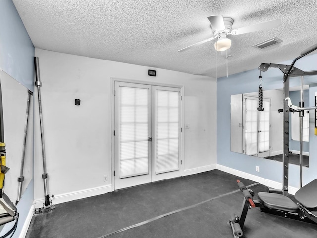 exercise area featuring a ceiling fan, visible vents, a textured ceiling, and baseboards