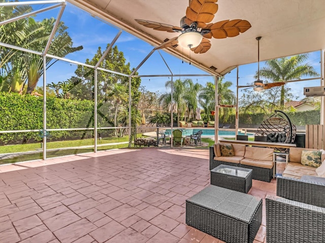 view of patio / terrace with an outdoor pool, glass enclosure, ceiling fan, and an outdoor hangout area