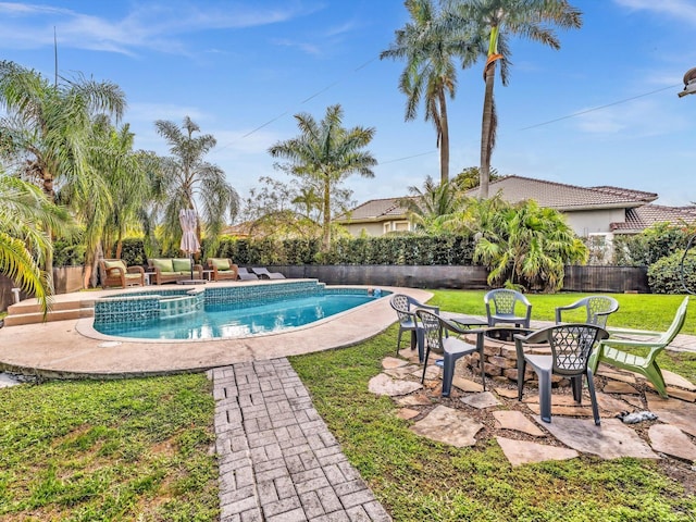 view of pool featuring a yard, a pool with connected hot tub, fence, and a patio