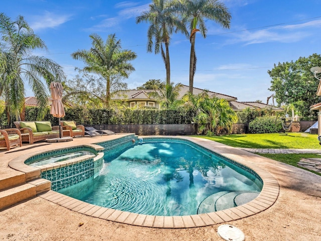 view of pool featuring a pool with connected hot tub, a lawn, and a patio