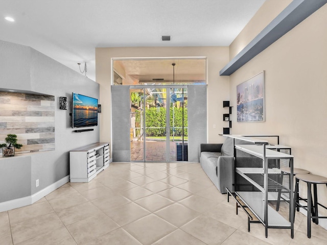 tiled living room featuring baseboards