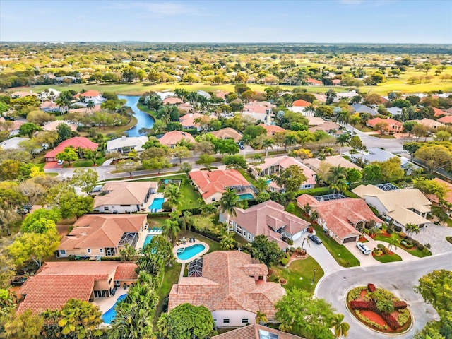 drone / aerial view featuring a water view and a residential view