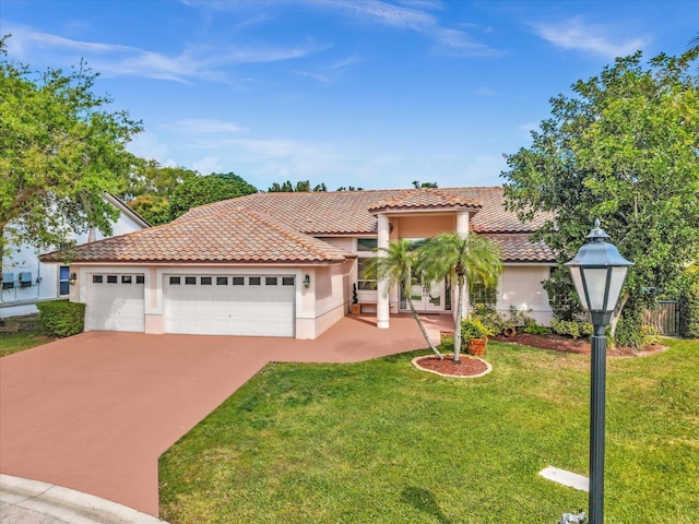 view of front of home featuring an attached garage, a tile roof, concrete driveway, stucco siding, and a front lawn