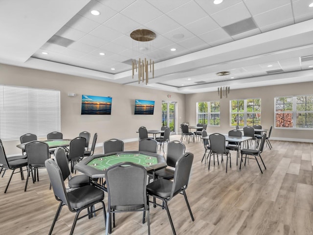 dining space with a tray ceiling, recessed lighting, light wood-type flooring, a drop ceiling, and baseboards