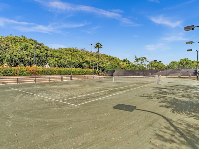 view of sport court featuring fence