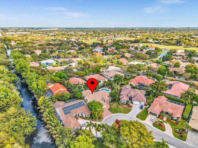 birds eye view of property with a water view and a residential view