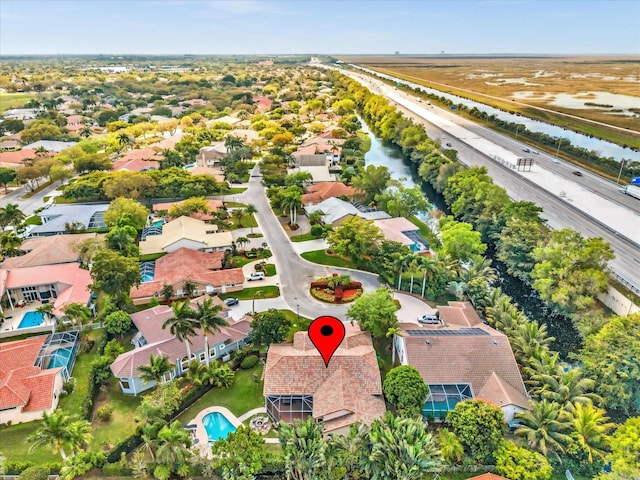 birds eye view of property with a water view and a residential view