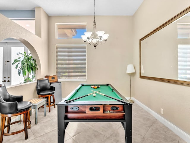 rec room featuring arched walkways, a chandelier, tile patterned flooring, pool table, and baseboards