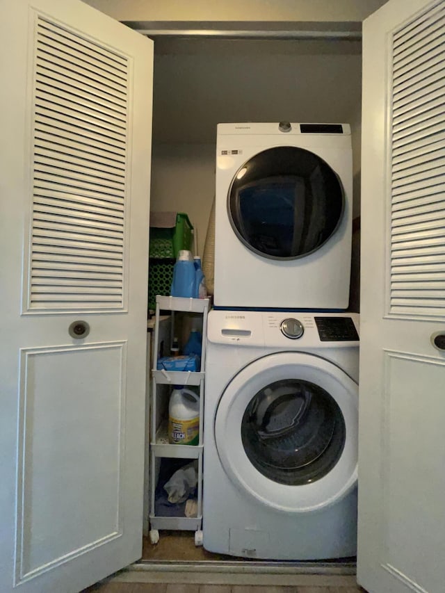 laundry area featuring stacked washer / dryer and laundry area