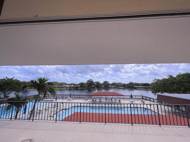 view of swimming pool featuring a water view